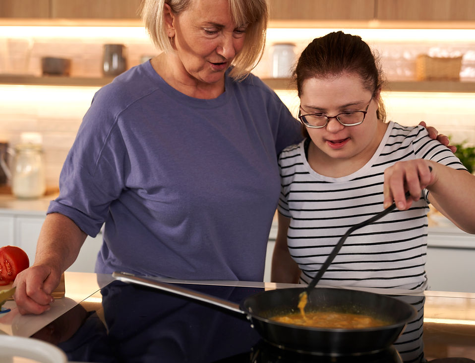 Mother and daughter cooking together at home